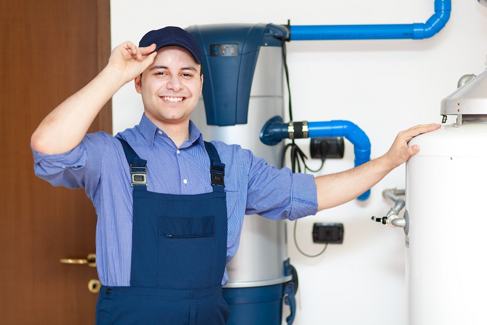 Boiler technician standing beside rental equipment